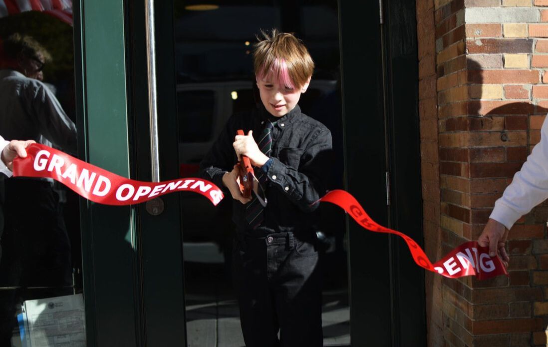 Cutting the ribbon at the grand reopening of the Mausert block.